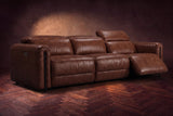 The Octavia 3 seat in Burnished Chestnut distressed full leather on a dark herringbone floor, the right recliner open and its headrest raised. Shown in Burnished Chestnut, 3 seat.