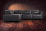 Octavia sectional in Aged Slate on a walnut herringbone floor, seen from the front, footrests closed, Left bumper.