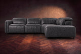 Octavia sectional in Aged Slate on a walnut herringbone floor, seen from the front, footrests closed, Right bumper.