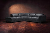 Octavia sectional in Aged Slate on a walnut herringbone floor, low three-quarter view from further back, footrests closed, Left bumper.