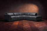 Octavia sectional in Aged Slate on a walnut herringbone floor, low three-quarter view from further back, footrests closed, Right bumper.