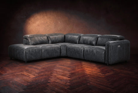 Octavia sectional in Aged Slate on a walnut herringbone floor, three-quarter view, headrests down and footrests closed, Left bumper.