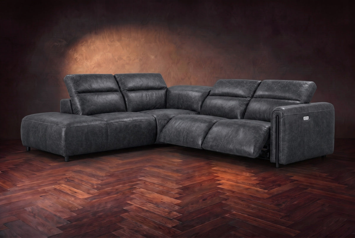 Octavia sectional in Aged Slate on a walnut herringbone floor, three-quarter view, both recliners open and the headrests raised, Left bumper.