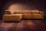 Octavia sectional in Antiqued Caramel on a walnut herringbone floor, seen from the front, footrests closed, Left bumper.