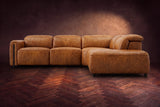 Octavia sectional in Antiqued Caramel on a walnut herringbone floor, seen from the front, footrests closed, Right bumper.