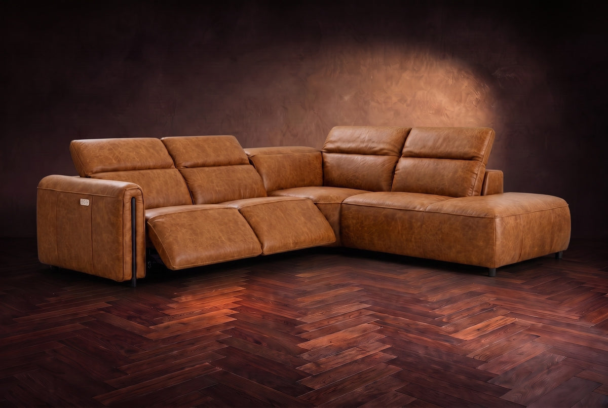 Octavia sectional in Antiqued Caramel on a walnut herringbone floor, three-quarter view, both recliners open and the headrests raised, Right bumper.