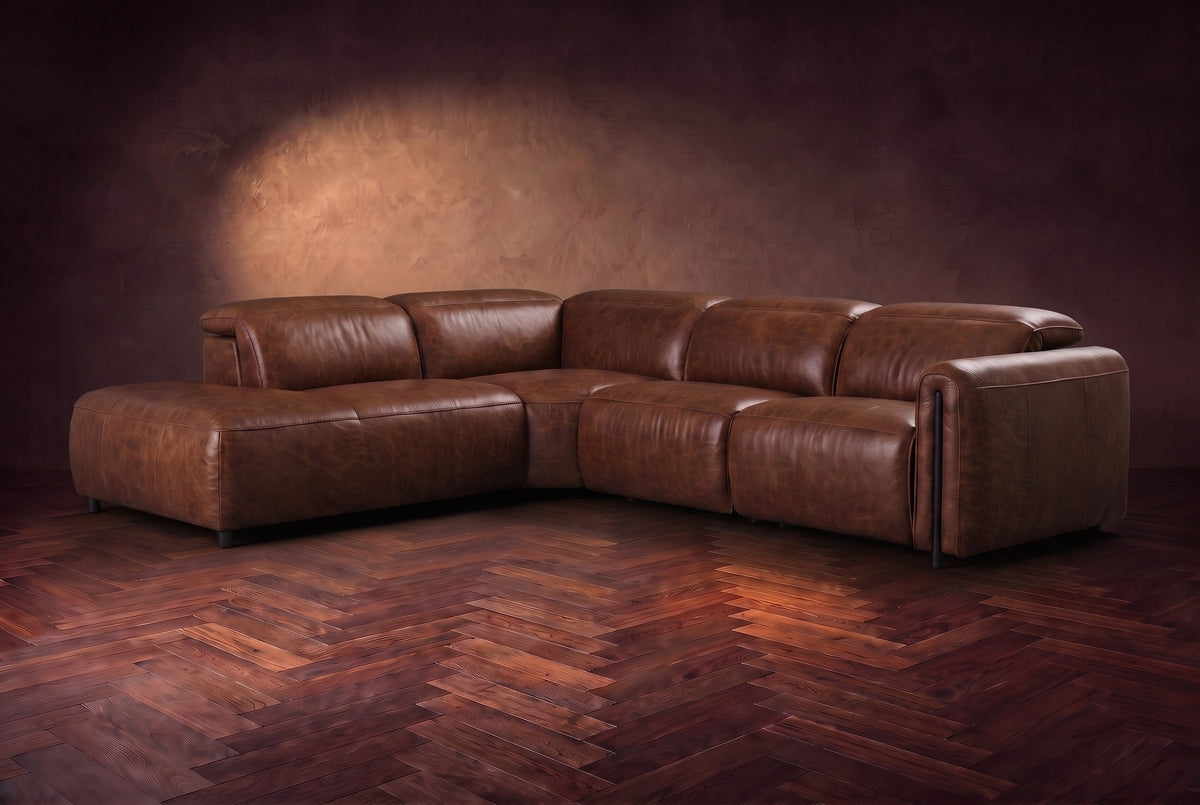 Octavia sectional in Burnished Chestnut on a walnut herringbone floor, three-quarter view, headrests down and footrests closed, Left bumper.