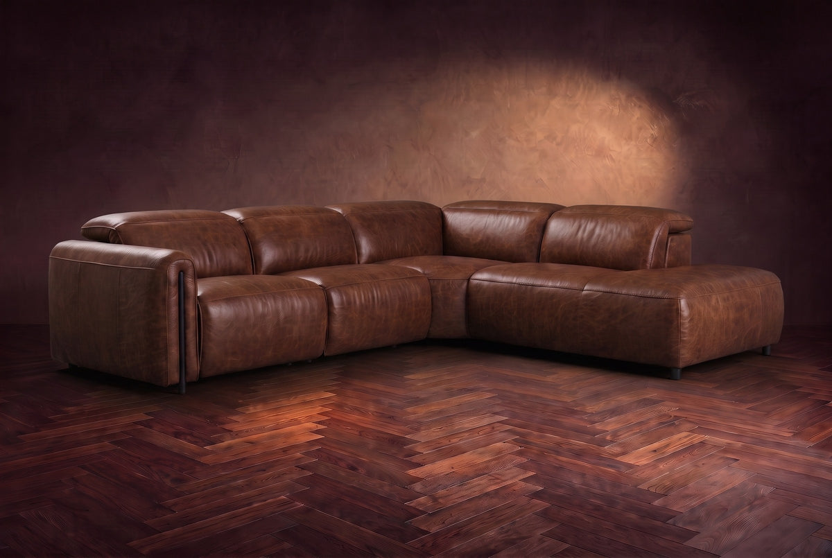 Octavia sectional in Burnished Chestnut on a walnut herringbone floor, three-quarter view, headrests down and footrests closed, Right bumper.