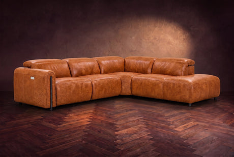 Octavia sectional in Tuscan Cognac on a walnut herringbone floor, three-quarter view, headrests down and footrests closed, Right bumper.