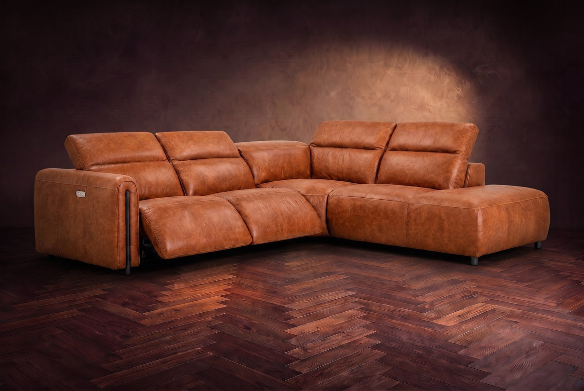 Octavia sectional in Tuscan Cognac on a walnut herringbone floor, three-quarter view, both recliners open and the headrests raised, Right bumper.