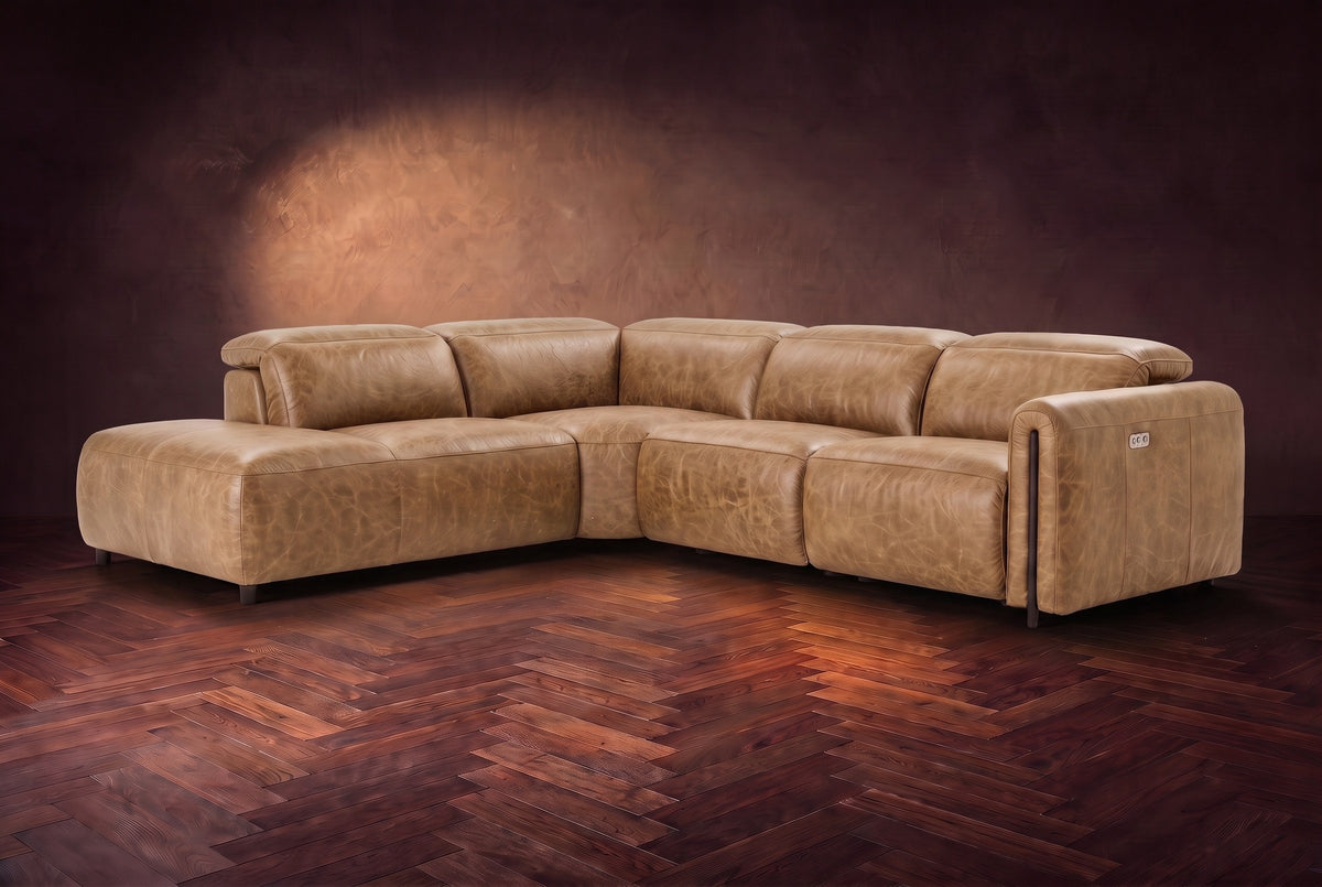 Octavia sectional in Washed Sand on a walnut herringbone floor, three-quarter view, headrests down and footrests closed, Left bumper.