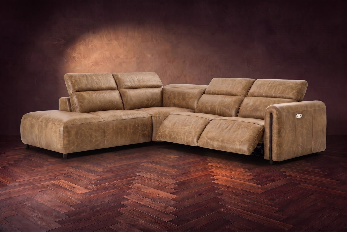 Octavia sectional in Washed Sand on a walnut herringbone floor, three-quarter view, both recliners open and the headrests raised, Left bumper.