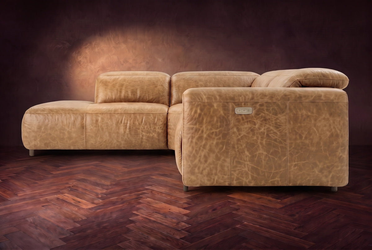 Octavia sectional in Washed Sand on a walnut herringbone floor, seen from the arm end, footrests closed, Left bumper.