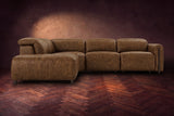 Octavia sectional in Weathered Saddle on a walnut herringbone floor, seen from the front, footrests closed, Left bumper.