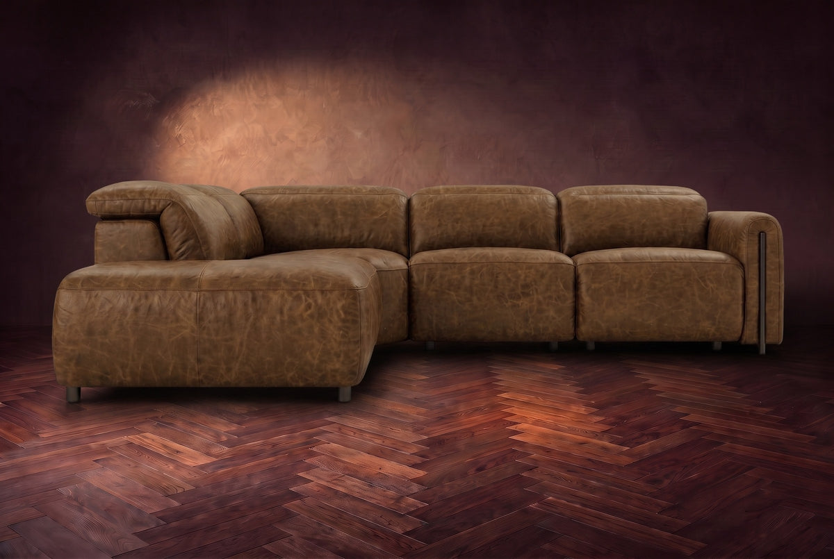 Octavia sectional in Weathered Saddle on a walnut herringbone floor, seen from the front, footrests closed, Left bumper.