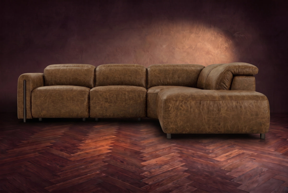 Octavia sectional in Weathered Saddle on a walnut herringbone floor, seen from the front, footrests closed, Right bumper.