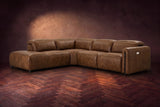 Octavia sectional in Weathered Saddle on a walnut herringbone floor, three-quarter view, headrests down and footrests closed, Left bumper.