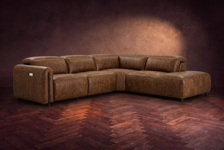 Octavia sectional in Weathered Saddle on a walnut herringbone floor, three-quarter view, headrests down and footrests closed, Right bumper.