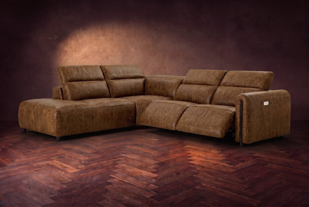 Octavia sectional in Weathered Saddle on a walnut herringbone floor, three-quarter view, both recliners open and the headrests raised, Left bumper.