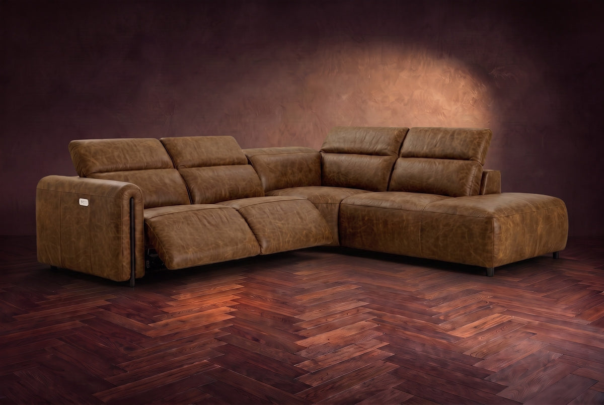 Octavia sectional in Weathered Saddle on a walnut herringbone floor, three-quarter view, both recliners open and the headrests raised, Right bumper.