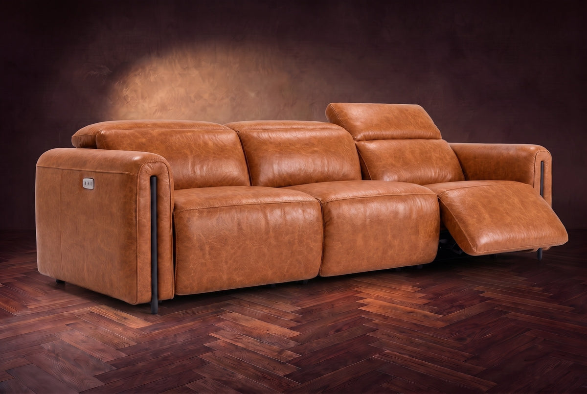 The Octavia 3 seat in Tuscan Cognac distressed full leather on a dark herringbone floor, the right recliner open and its headrest raised. Shown in Tuscan Cognac, 3 seat.