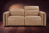 The Octavia loveseat in Washed Sand distressed full leather on a dark herringbone floor, seen from the front, the right headrest raised. Shown in Washed Sand, Loveseat.
