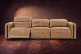 The Octavia 3 seat in Washed Sand distressed full leather on a dark herringbone floor, seen from the front, the left recliner open and its headrest raised. Shown in Washed Sand, 3 seat.