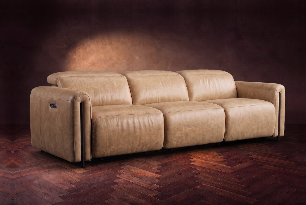 The Octavia 3 seat in Washed Sand distressed full leather on a dark herringbone floor, headrests down and footrests closed. Shown in Washed Sand, 3 seat.