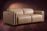 The Octavia loveseat in Washed Sand distressed full leather on a dark herringbone floor, headrests down and footrests closed. Shown in Washed Sand, Loveseat.