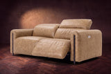 The Octavia loveseat in Washed Sand distressed full leather on a dark herringbone floor, seen from the right, the right recliner open and its headrest raised. Shown in Washed Sand, Loveseat.