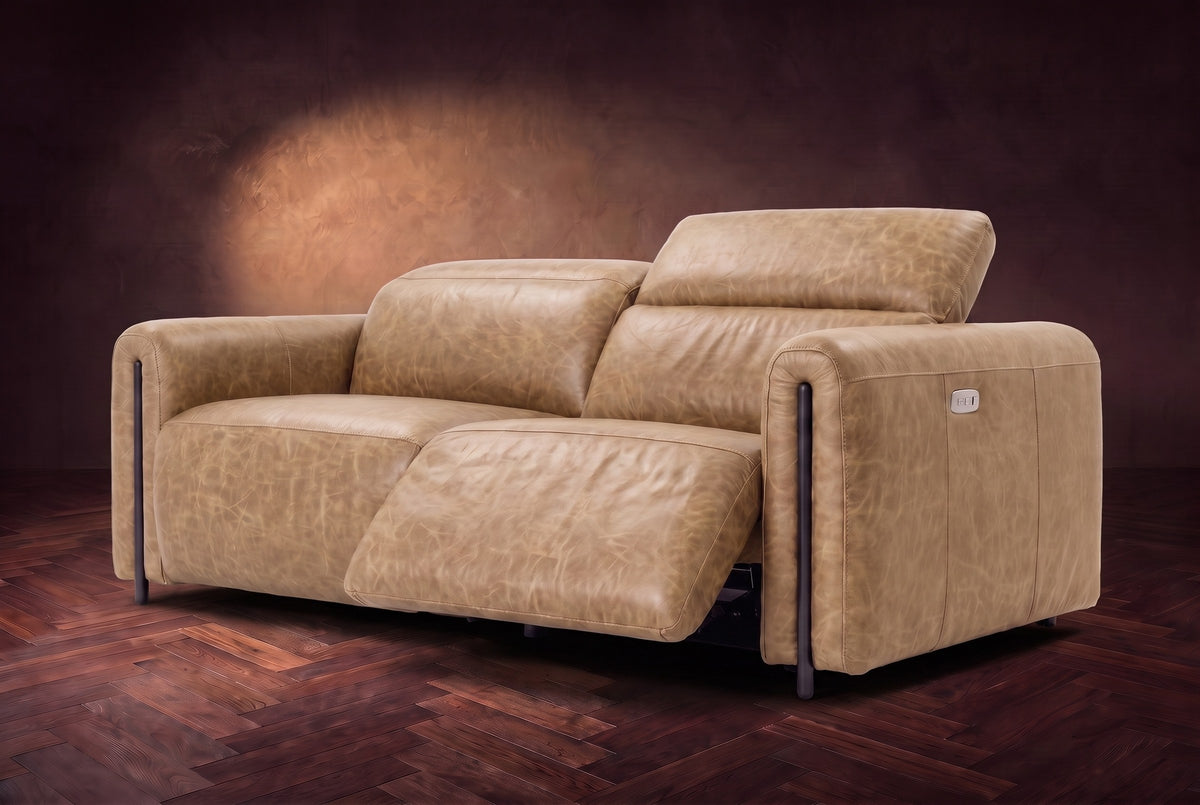 The Octavia loveseat in Washed Sand distressed full leather on a dark herringbone floor, seen from the right, the right recliner open and its headrest raised. Shown in Washed Sand, Loveseat.