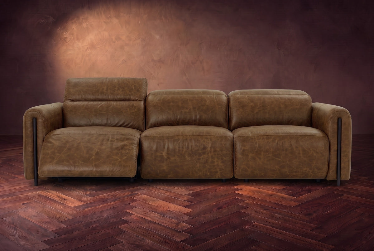 The Octavia 3 seat in Weathered Saddle distressed full leather on a dark herringbone floor, seen from the front, the left recliner open and its headrest raised. Shown in Weathered Saddle, 3 seat.