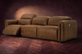 The Octavia 3 seat in Weathered Saddle distressed full leather on a dark herringbone floor, seen from the right, the left recliner open and its headrest raised. Shown in Weathered Saddle, 3 seat.