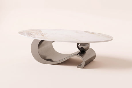 The Ondina coffee table in Gray, front view: a white veined sintered stone oval on one polished gray steel ribbon that curls, dips and scrolls, with a gray sphere resting on it, on an off-white studio background