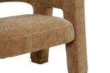 Close-up of the Opi arm turning down into the front leg at a rounded corner, the ribbed Chai fabric and a rubberwood foot