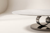 Close-up of the Oriana coffee table's white sintered stone top with soft grey veining, its slim straight edge and the gunmetal ring below