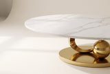 Close-up of the Oriana coffee table's white sintered stone top with soft grey veining, its slim straight edge and the top of the gold ring below