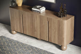 Orson mango wood sideboard styled with books and vases against a dark navy wall