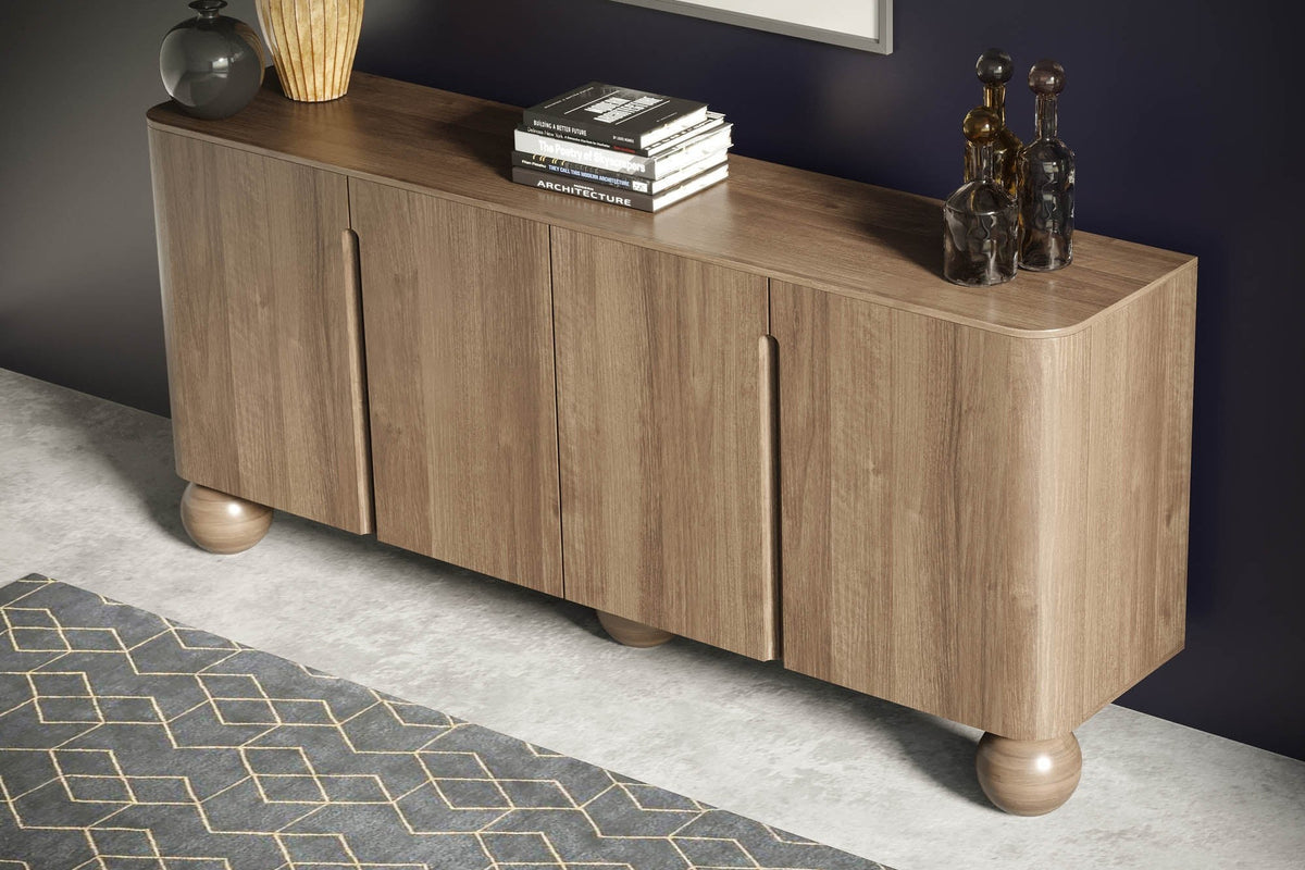 Orson mango wood sideboard styled with books and vases against a dark navy wall
