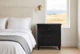 Ortona nightstand in Black beside a boucle bed in a Calgary bedroom with foothills in the window
