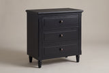 Ortona 3-drawer nightstand in Black, three-quarter view on a warm grey studio backdrop