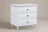 Ortona 3-drawer nightstand in White, three-quarter view on a warm grey studio backdrop