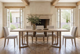 Orvieto dining table in a Provencal stone dining room with a stone fireplace and French doors to the lavender