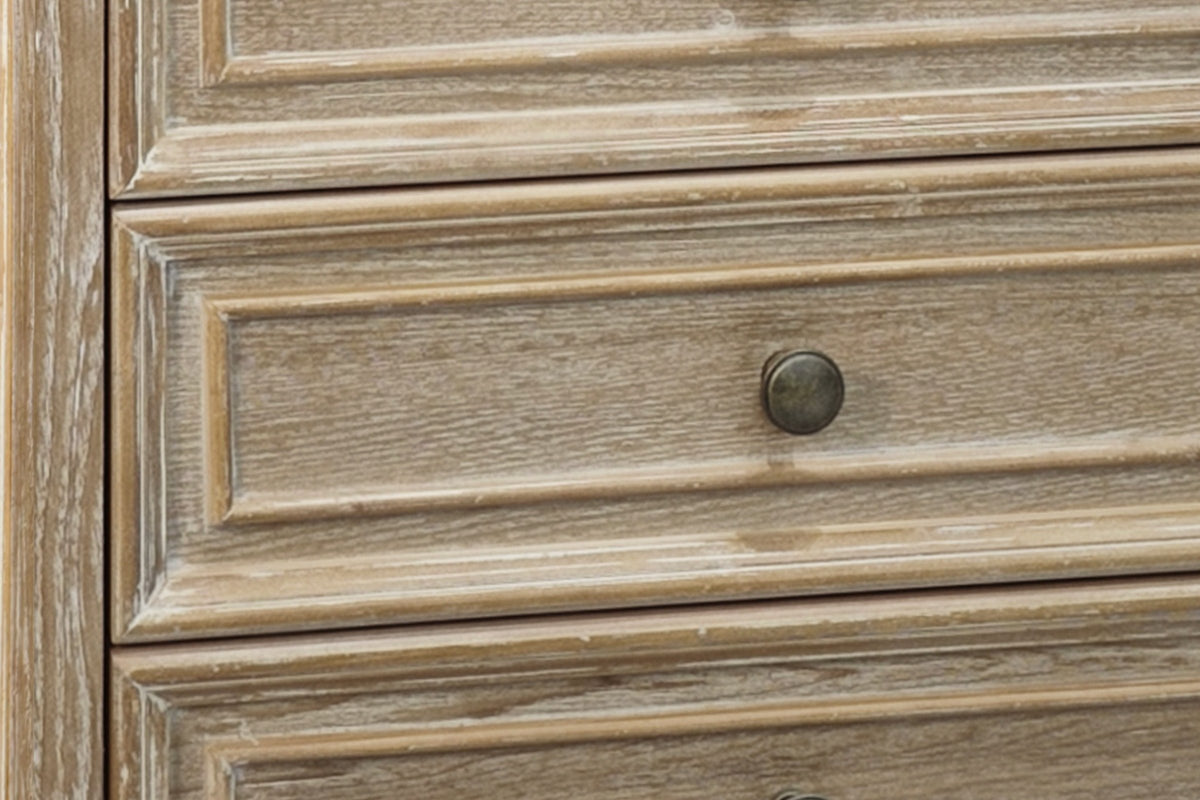 Close-up of the Natural White finish: white-washed open ash grain with distressed edges on the framed drawer fronts