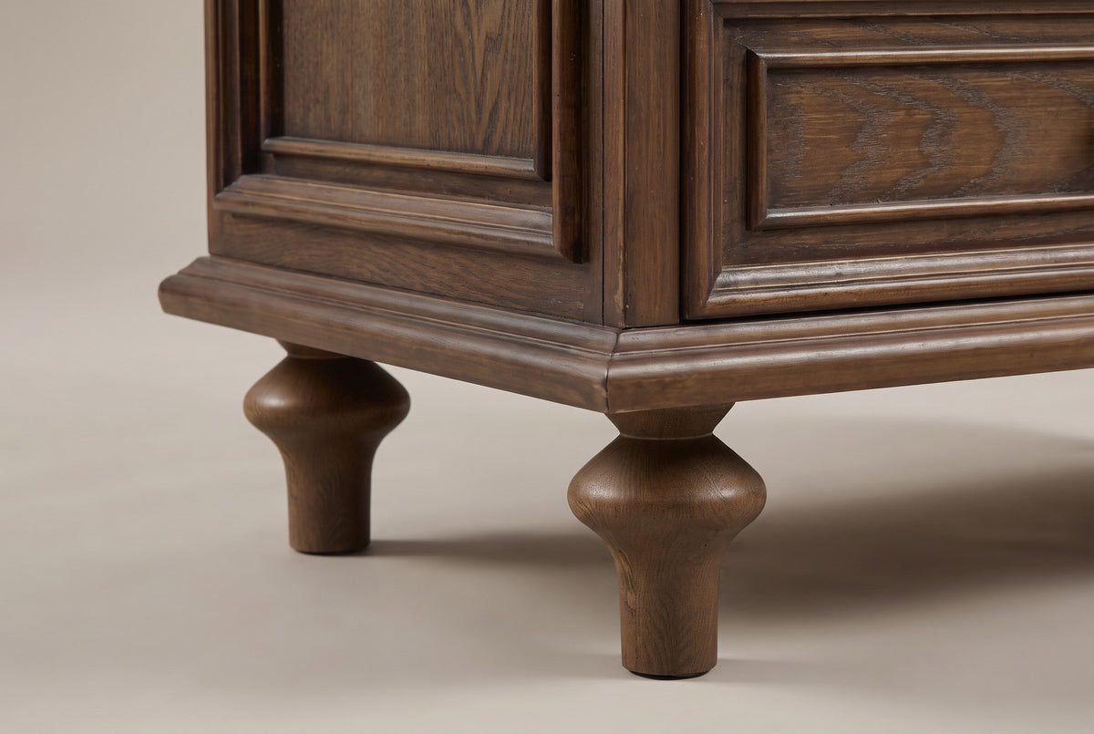 Close-up of the stepped plinth and two turned pine legs