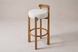 Otricoli bar stool in Ivory woven fabric, three-quarter view on a warm grey studio backdrop