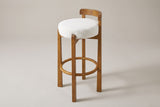 Otricoli bar stool in White boucle-look fabric, three-quarter view on a warm grey studio backdrop