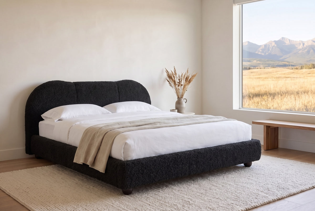 Padula bed in black in a bright bedroom with a wide window onto grassland and the Rocky Mountains