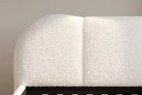 Close-up of the white teddy bouclé headboard: its rounded corner and one seam