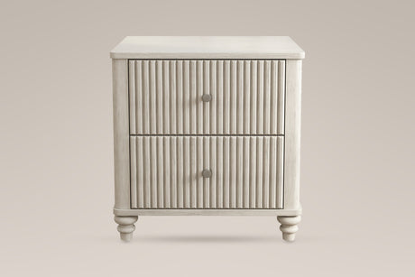 Palestrina nightstand in Beige, straight front view: two fluted drawers with round brushed-silver knobs, rounded corner posts